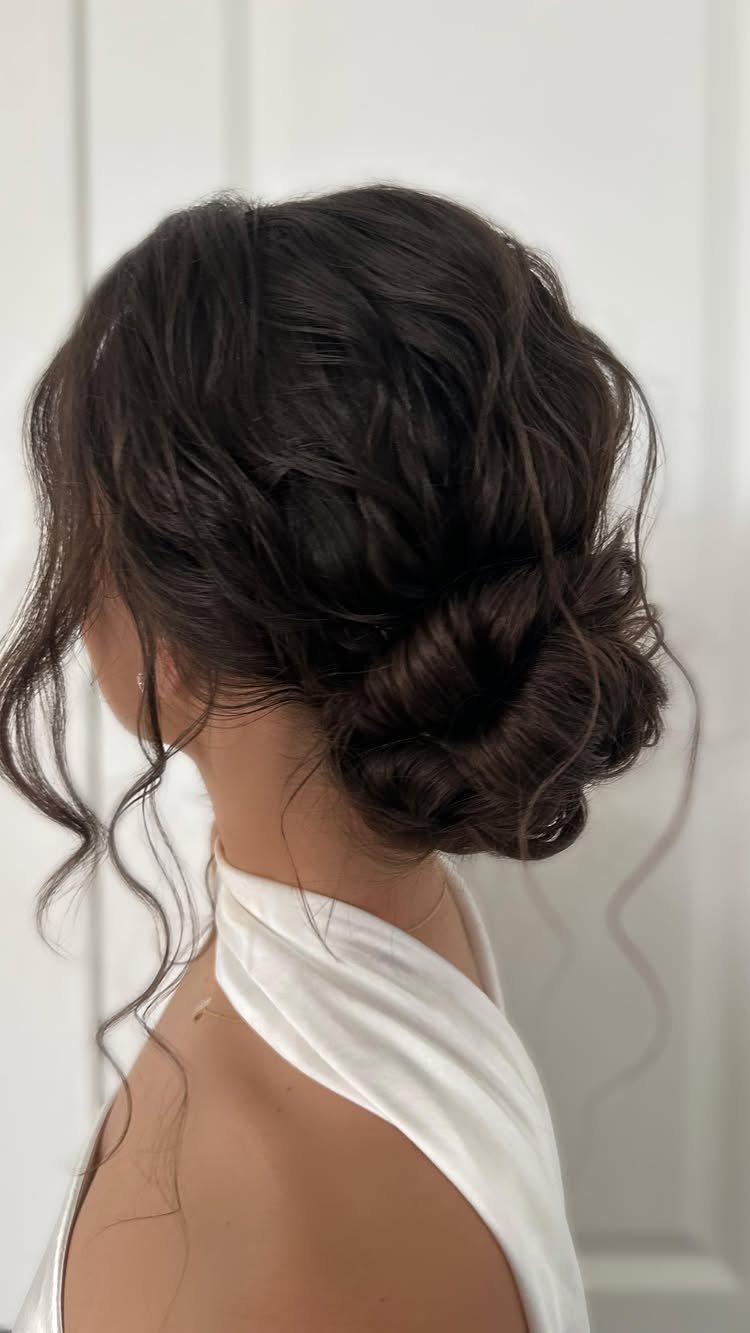 Wedding Updo Low Bun: How to Style 17 Beautiful Ideas 12 Woman with dark brown hair in a soft, romantic low bridal updo.