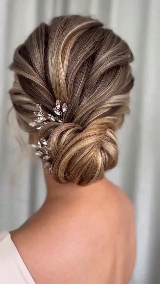 Wedding Updo Low Bun: How to Style 17 Beautiful Ideas 3 Textured low bun with blonde highlights and a silver floral hair accessory.