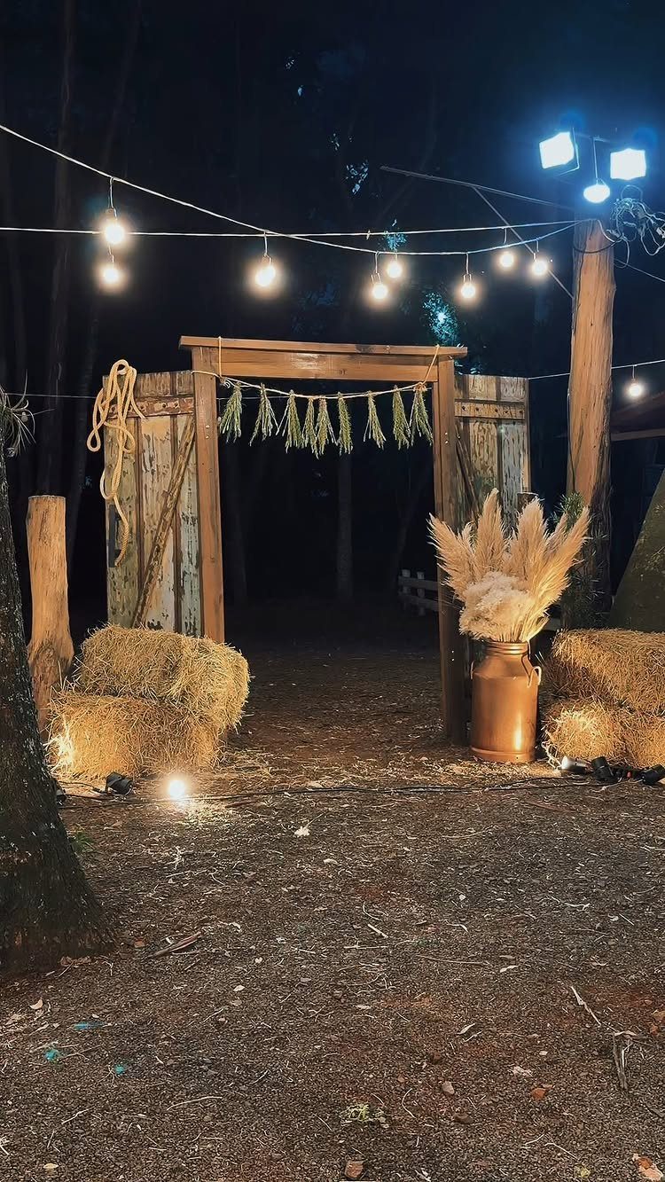 What Are the Best Western Themed Wedding Ideas? 37 Here 38 Rustic wooden wedding arch with hay bales and string lights in a forest