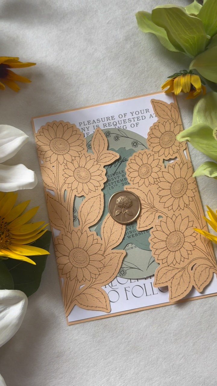 What Are the Best Western Themed Wedding Ideas? 37 Here 20 Wedding invitation with a brown laser-cut sunflower jacket and a small coin for scale.