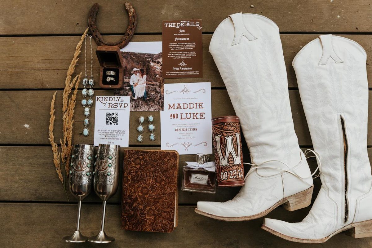 What Are the Best Western Themed Wedding Ideas? 37 Here 11 Wedding rings in a box beside white cowboy boots and western wedding invitations.