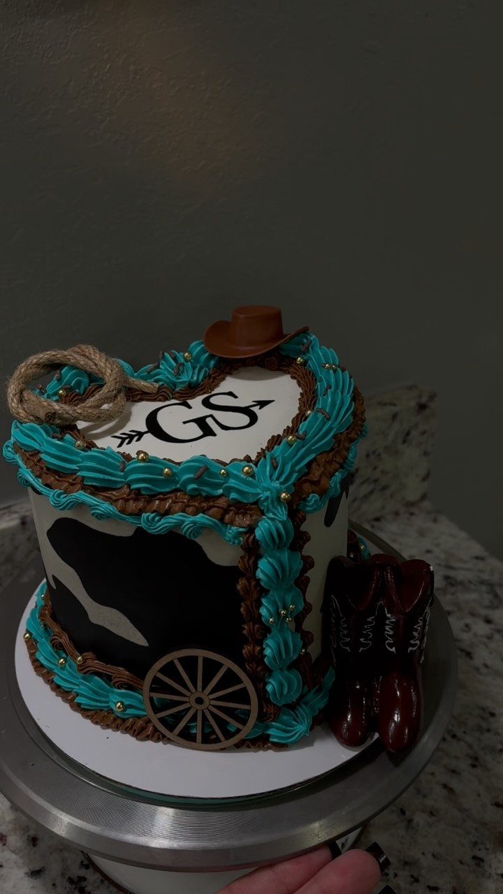 What Are the Best Western Themed Wedding Ideas? 37 Here 4 Western wedding cake with turquoise frosting, cowhide pattern, cowboy boots, and a hat.