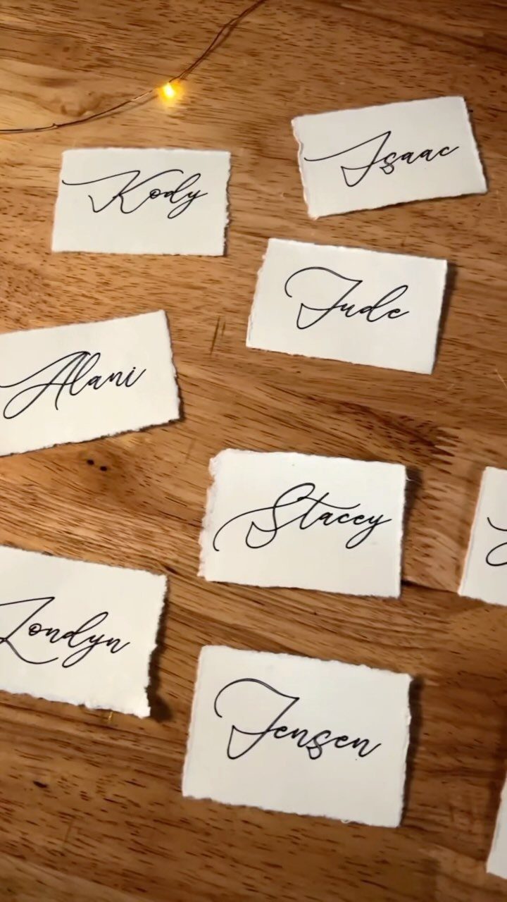 What Are the Best Western Themed Wedding Ideas? 37 Here 29 Hand-torn white paper name cards with black calligraphy on a wooden surface.