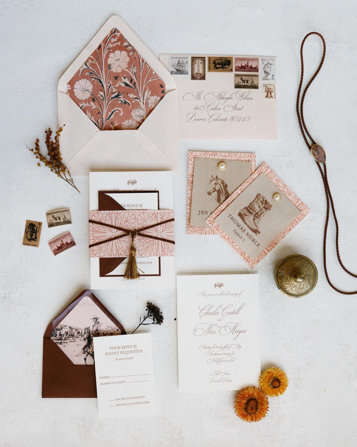 Western wedding invitation suite with horse illustrations, brown envelopes, and leather accents.