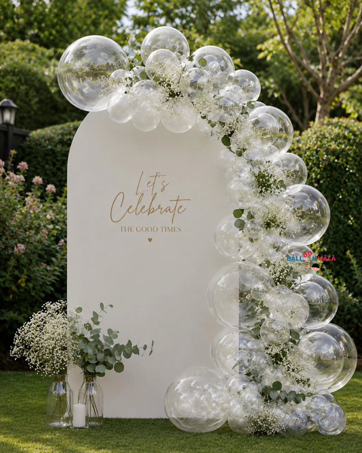 White Wedding Ideas: 23 Elegant Details for Your Big Day 11 White arched backdrop with clear and white balloon installation and greenery outdoors.