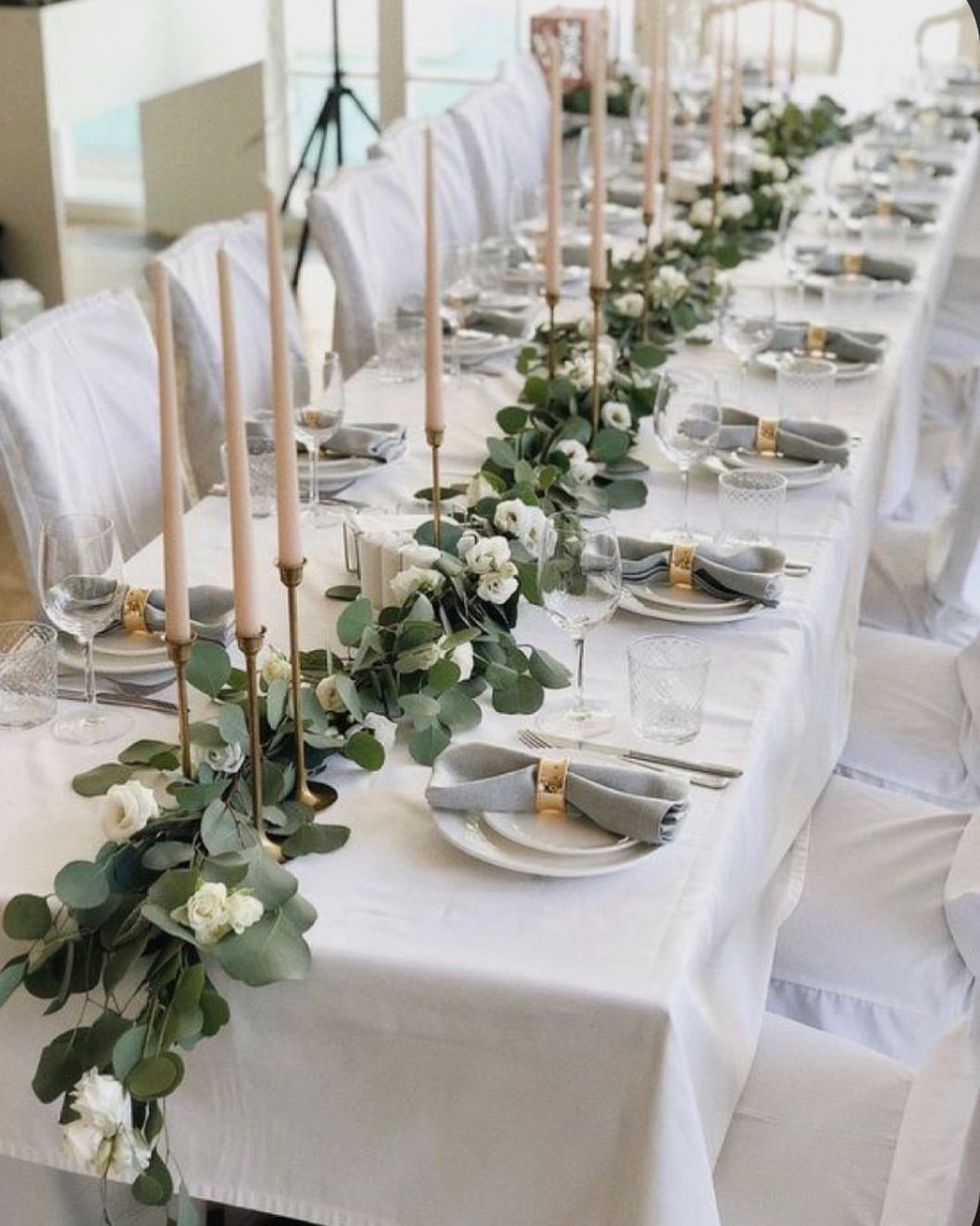 White Wedding Ideas: 23 Elegant Details for Your Big Day 14 White wedding table with greenery garland runner, white roses, and tall candles.
