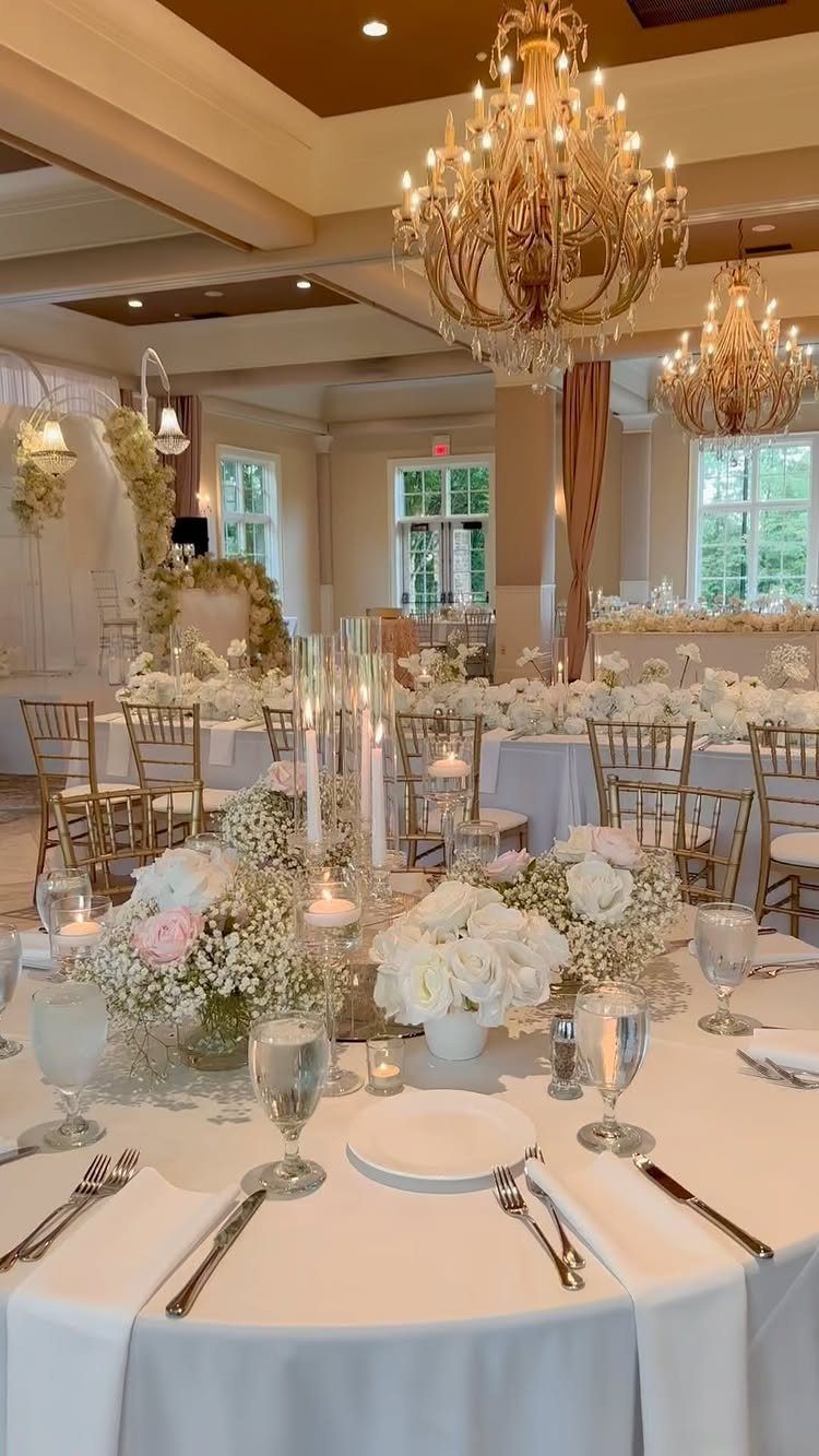 White Wedding Ideas: 23 Elegant Details for Your Big Day 12 White floral centerpieces with roses and baby's breath on a white wedding table.