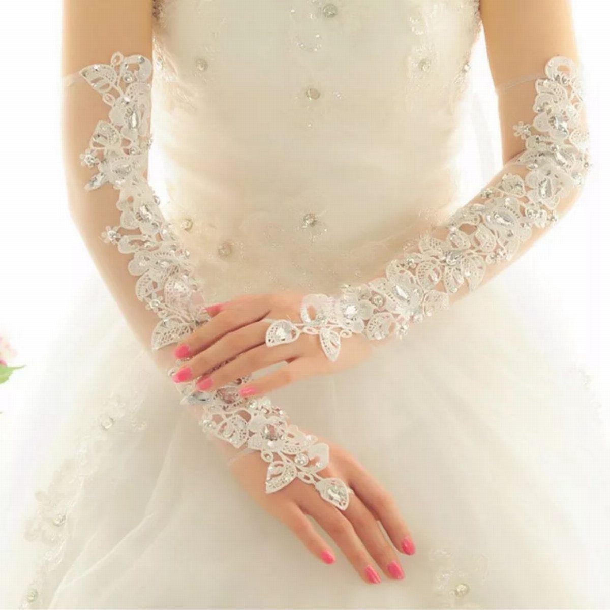 White Wedding Ideas: 23 Elegant Details for Your Big Day 15 White lace fingerless wedding gloves with floral embroidery on a bridal gown