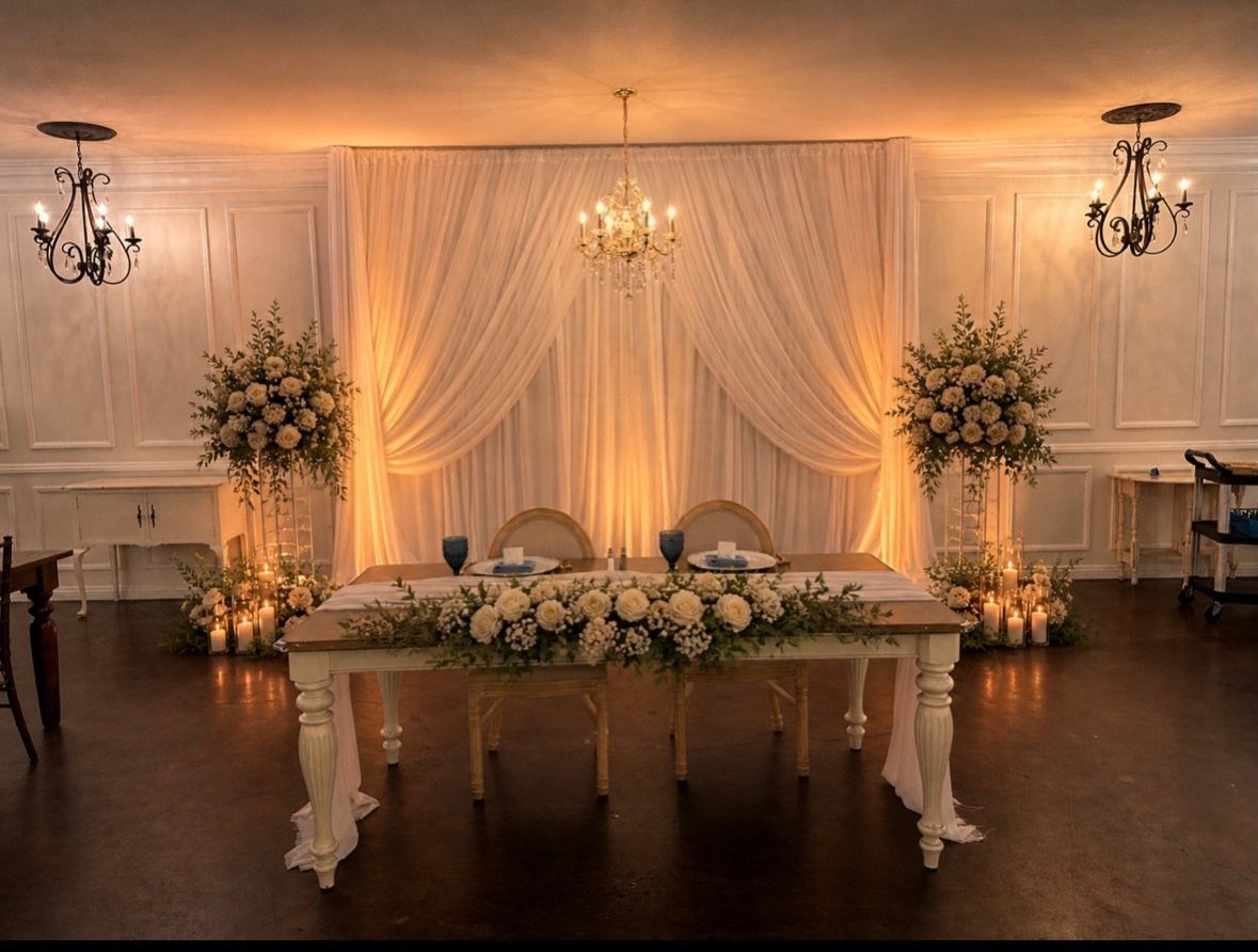 White Wedding Ideas: 23 Elegant Details for Your Big Day 24 White wedding table with floral centerpieces and draped white fabric backdrop