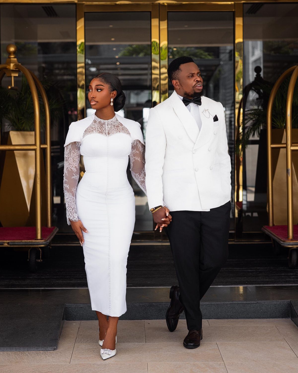 White Wedding Ideas: 23 Elegant Details for Your Big Day 3 Couple in white bridal gown and white tuxedo jacket walking together outdoors.
