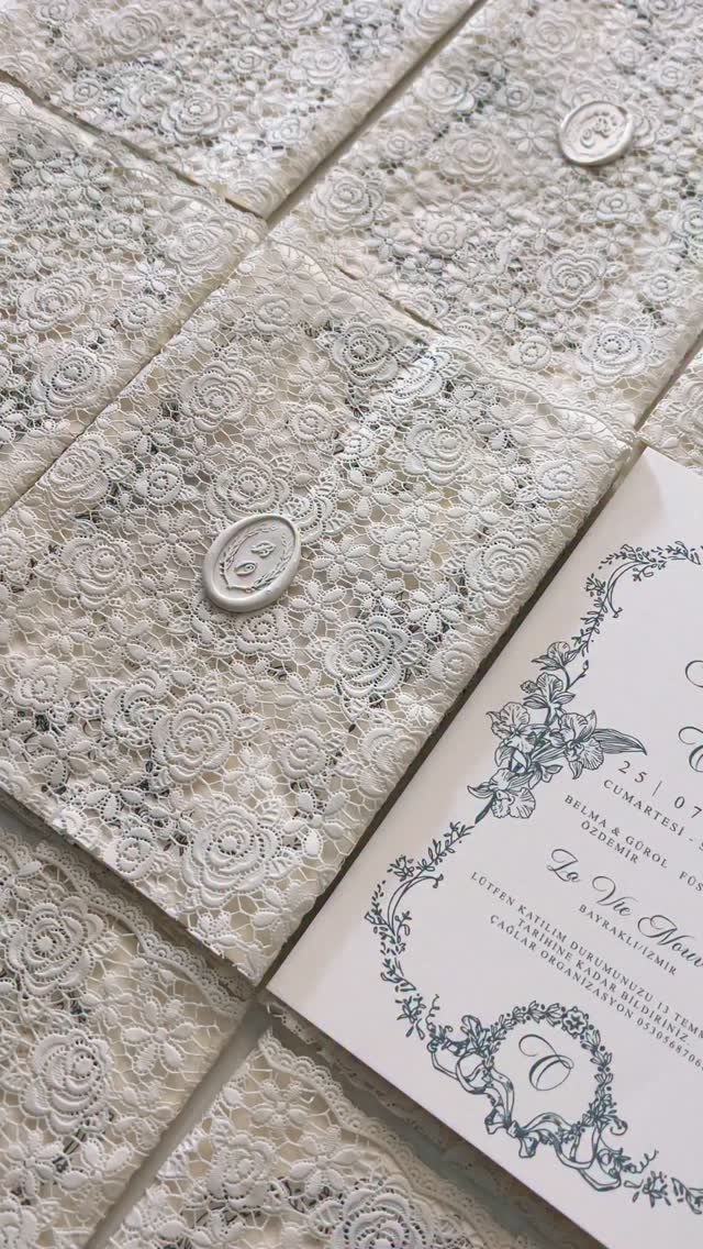 White Wedding Ideas: 23 Elegant Details for Your Big Day 5 White lace fabric squares with wax seals and a floral wedding invitation.
